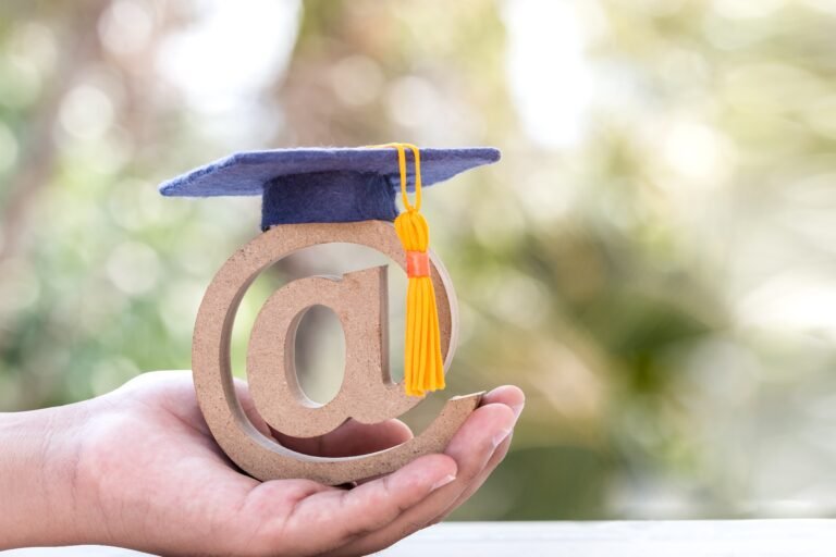 online-learning-in-study-abroad-university-education-concept-graduation-cap-on-email-address-symbol-in-student-hands-ideas-communication-international-school-can-learn-course-by-internet-technology